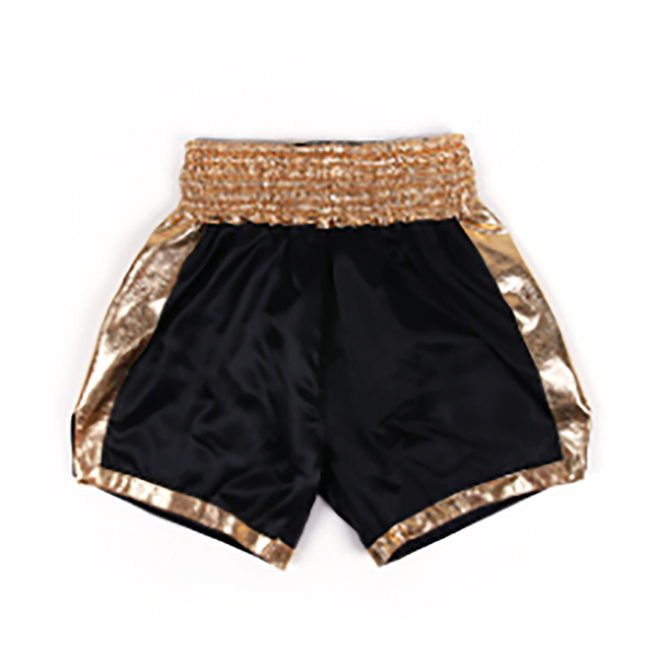 Black athletic shorts with shiny metallic gold trim along the waistband, side panels, and hem, shown against a plain white background.
